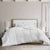 A DOWNLITE White Goose Down Comforter | Medium Weight, on a bed in a bedroom.