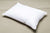 An eco-friendly Envirosleep Resiloft Soft Pillow by Manchester Mills rests on a white surface.