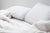 A white Envirosleep Dream Surrender & Dream Surrender Firm Combo Pack bed with pillows and blankets, perfect for surrendering to sweet dreams. Brand Name: Manchester Mills