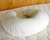 A Holy Lamb Organics Nursing Pillow Cover covered in organic cotton on a bed.