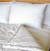 A Holy Lamb Organics Wool Comforter - Cool Comfort on the bed with organic cotton.