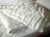 A Holy Lamb Organics Wool Comforter - Cool Comfort made with organic cotton on top of a wooden bed.