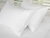 Two Down Etc. Premium Pillow Protectors with Teardrop Closure on top of a white bed.